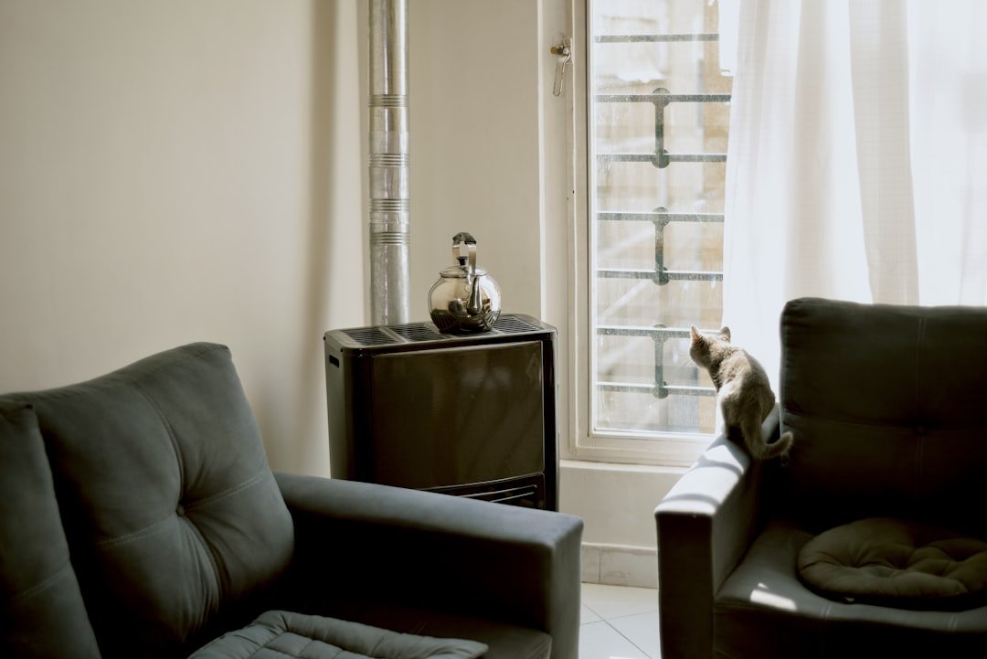 A living room with a couch, chair and television