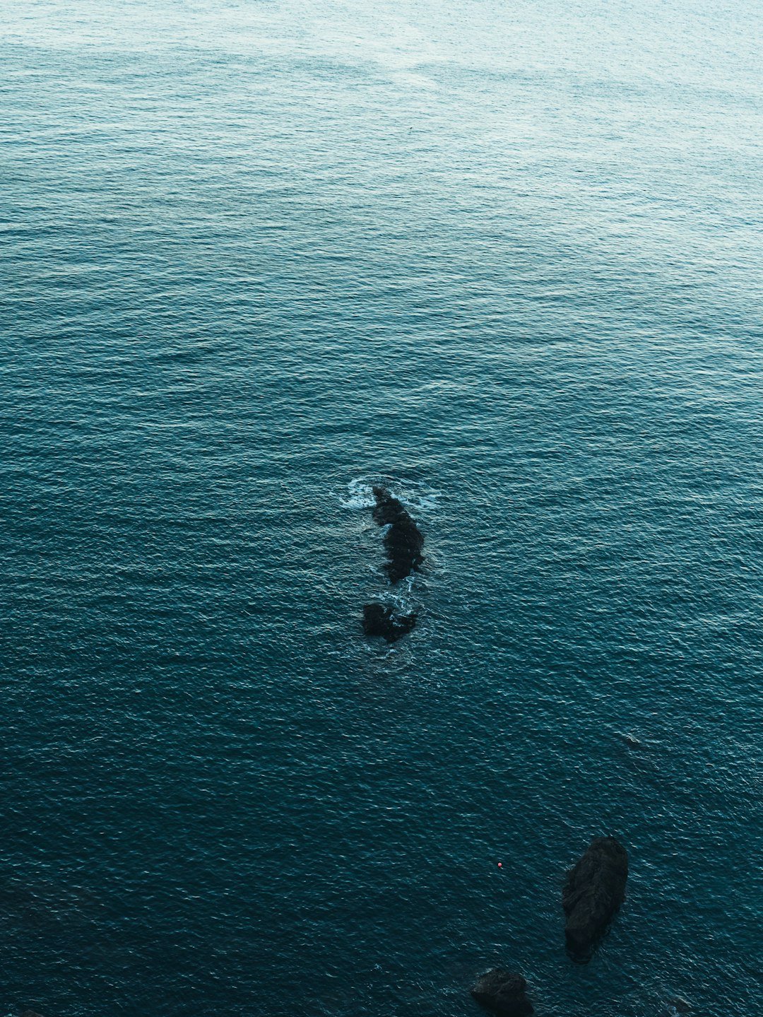 a large body of water with rocks in it